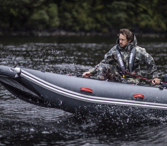 A man riding a tactician inflatable boat