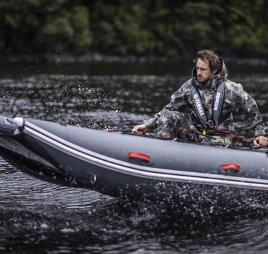A man riding a tactician inflatable boat
