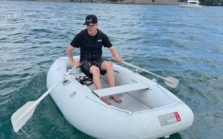 Man rowing a stowaway dinghy