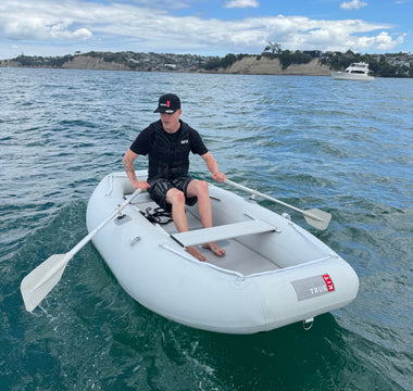 Man rowing a stowaway dinghy