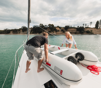 man and woman setting up sailboat