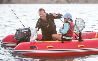 A man and his daughter fishing using Truekit inflatable boat