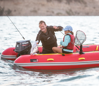 A man and his daughter fishing using Truekit inflatable boat