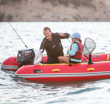 A man and his daughter fishing using Truekit inflatable boat