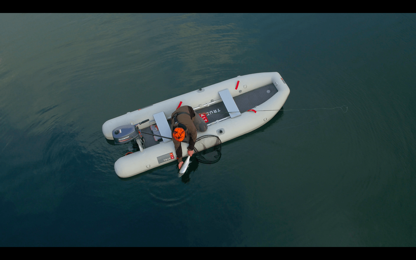 Inflatable Fishing Kayak - releasing a fish from the True Kit Tactician